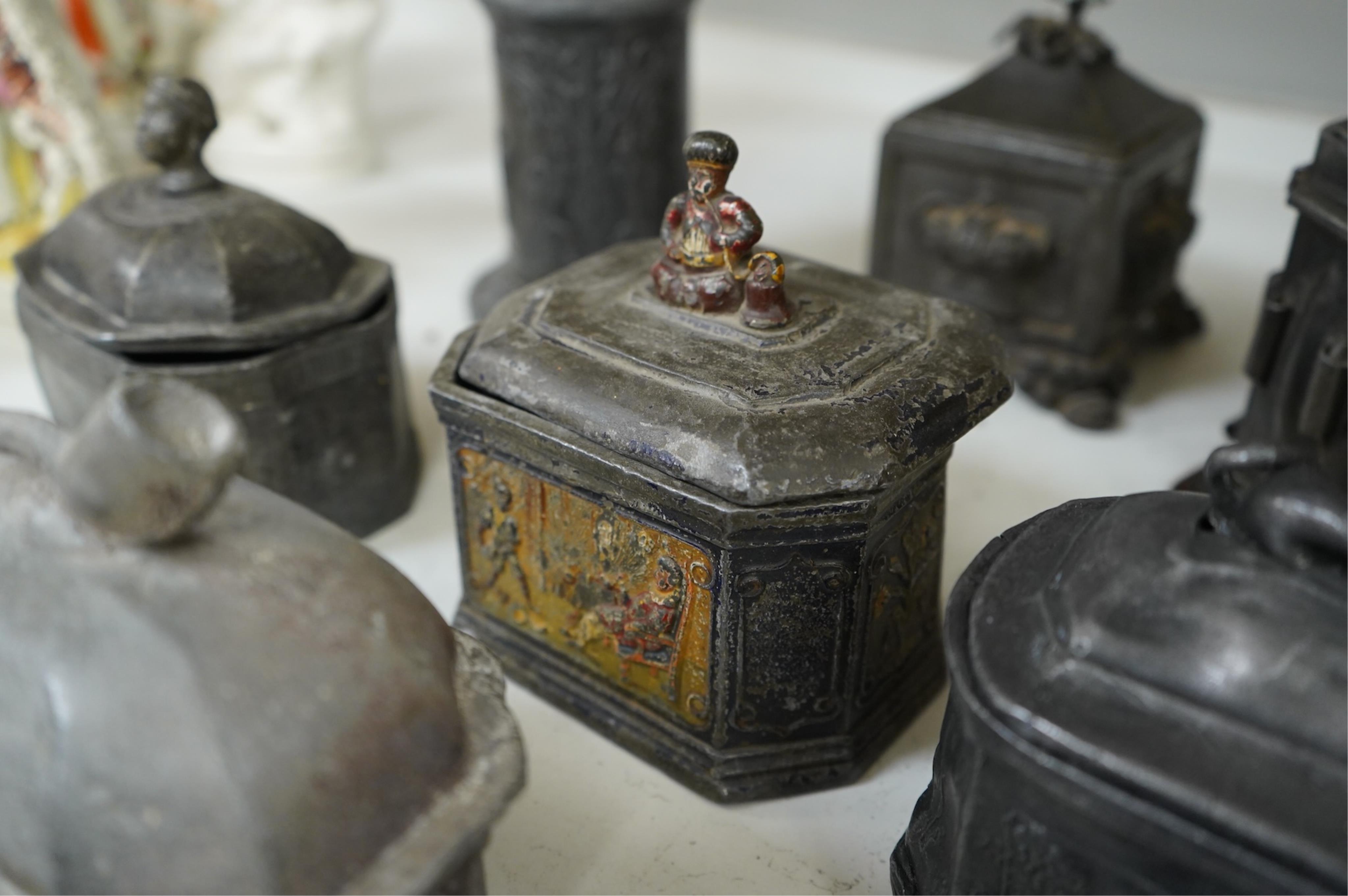 A collection of ten early 19th century lead tobacco boxes to include an octagonal example with remains of paintwork, largest 19cm high
